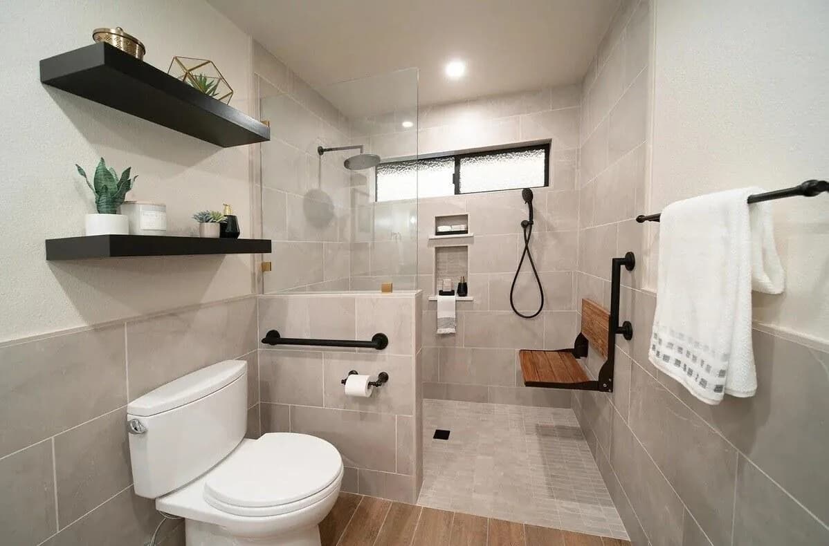 Curbless walk-in shower with a fold-down bench and grab bars